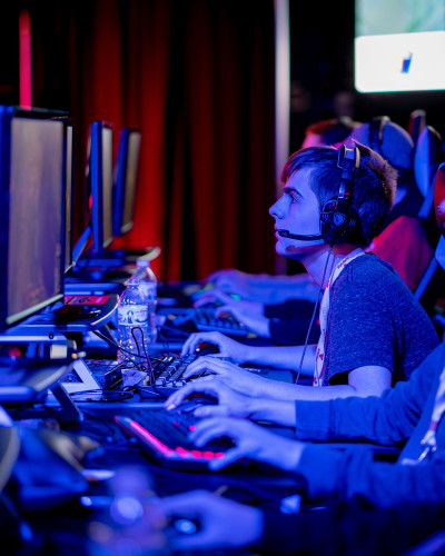 People on Computers competing in an esports tournament